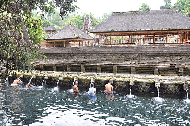 A bunch of people practices water healing in Tirta Empul Temple