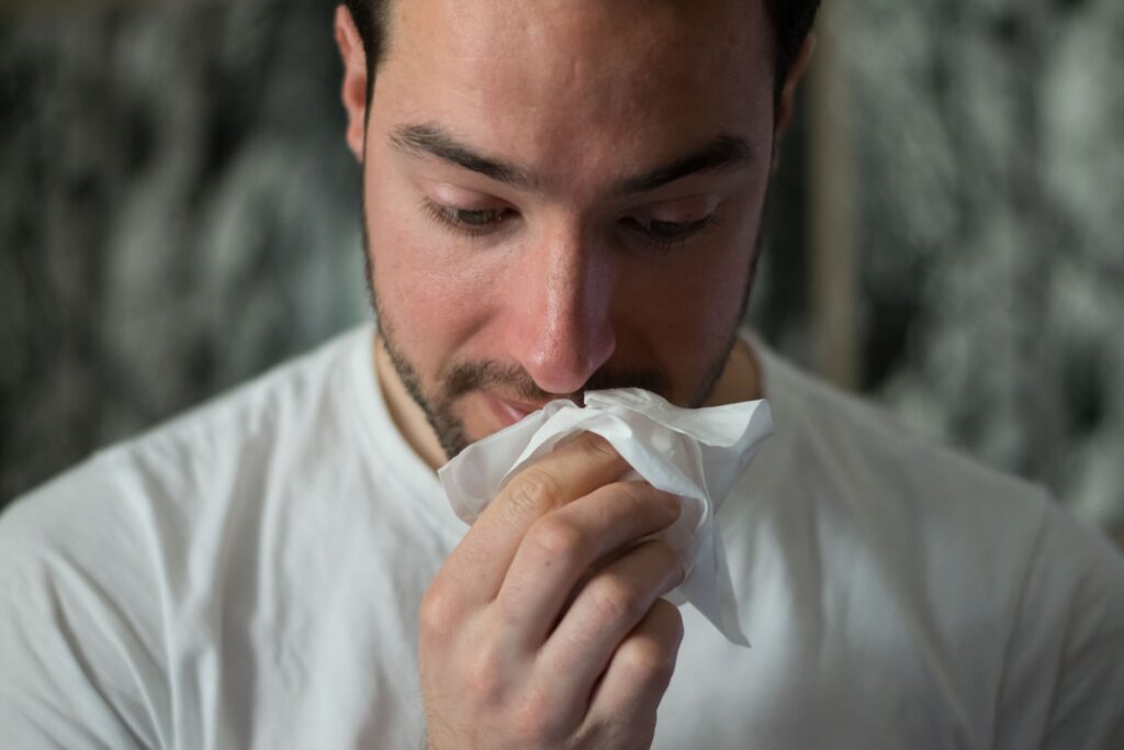 Man wiping his nose