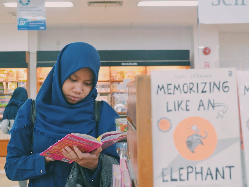 Woman thrift shopping books at the book store.