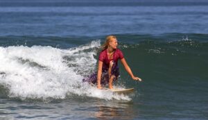 femare surfer is surfing in kabaya on kartini's day