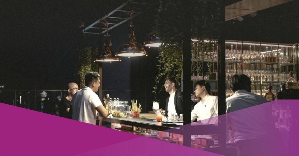 A group of people enjoy their drinks at rooftop bars in Jakarta